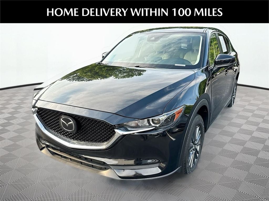 2021 Mazda Mazda CX-5 Touring in Jet Black Mica — front three-quarter view